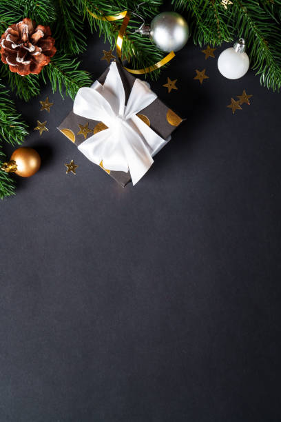 istock Black christmas background. Christmas present with golden decorations 2184013825