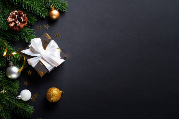 istock Black christmas background. Christmas present with golden decorations 2184013827