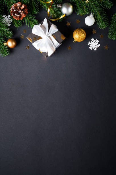 istock Black christmas background. Christmas present with golden decorations 2184013848
