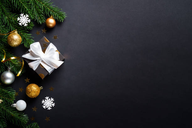 istock Black christmas background. Christmas present with golden decorations 2184013849