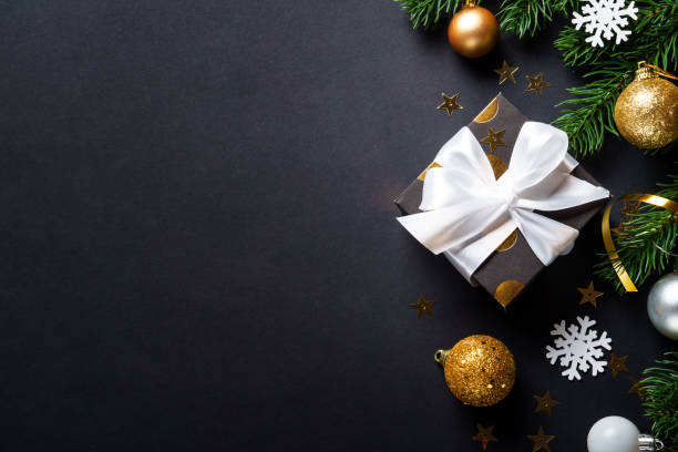 istock Black christmas background. Christmas present with golden decorations 2184013852