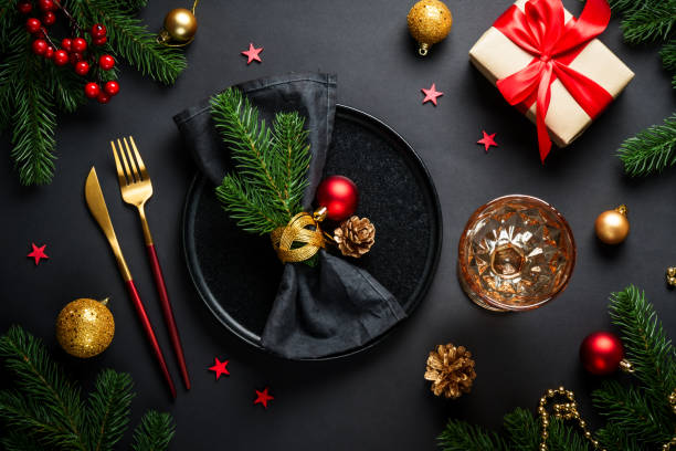 istock Christmas table setting with black plate, wine glass, cutlery and holidays decorations. 2184014068