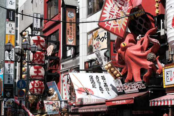 Colourful signboards on Dotonbori street, a busy shopping and entertainment street in Dōtonbori, a district in Osaka, Japan. Historically a theater district, it is now a popular nightlife area characterized by its eccentric atmosphere and large illuminated signboards.