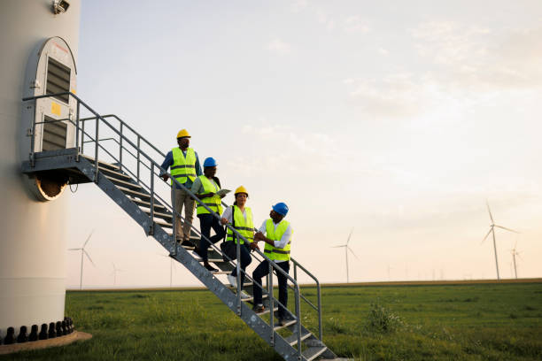 istock Engineers wearing uniform ,helmet hold document inspection work in wind turbine farms rotation to generate electricity energy. 2184017262