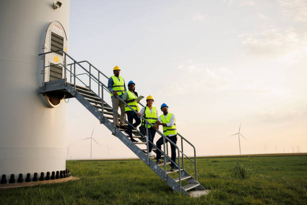istock Engineers wearing uniform ,helmet hold document inspection work in wind turbine farms rotation to generate electricity energy. 2184017314