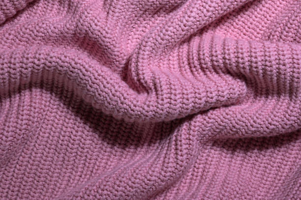 istock Soft pink knitted sweater fabric with cozy yarn details 2184017384