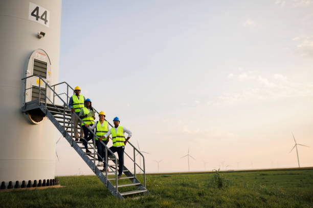 istock Engineers wearing uniform ,helmet hold document inspection work in wind turbine farms rotation to generate electricity energy. 2184017480
