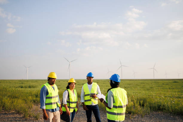 istock Engineers wearing uniform ,helmet hold document inspection work in wind turbine farms rotation to generate electricity energy 2184017523