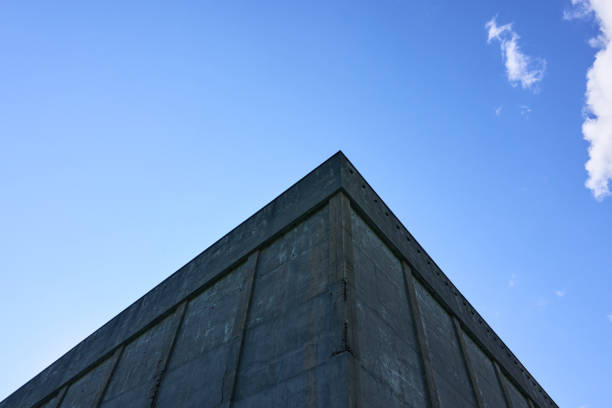 istock Minimalistic view of an old concrete building against a sunny blue sky 2184018761
