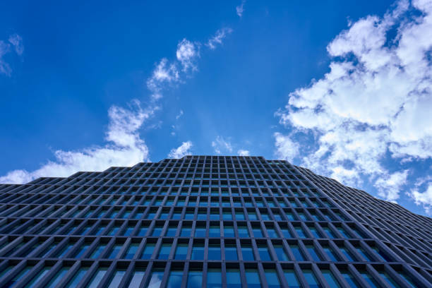 istock Modern skyscraper view from below against a bright blue sky, sleek and contemporary architecture 2184018823