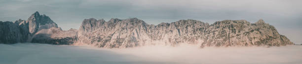 Sunrise over forest and mountains in mist, Slovenian Alps