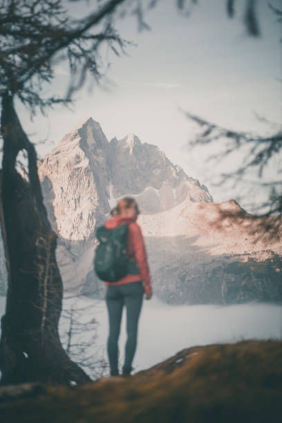 istock Young woman hiker stands on mountain pass 2184019210