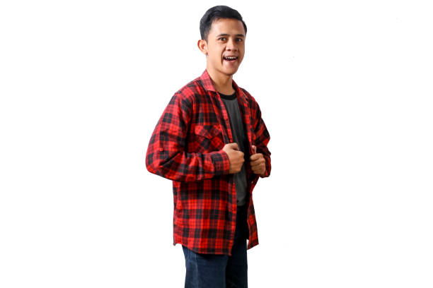 istock young man wearing red and black plaid shirt posing confidently having a cheerful expression, with both hands gripping the sides of his unbuttoned shirt isolated on white background 2184020699