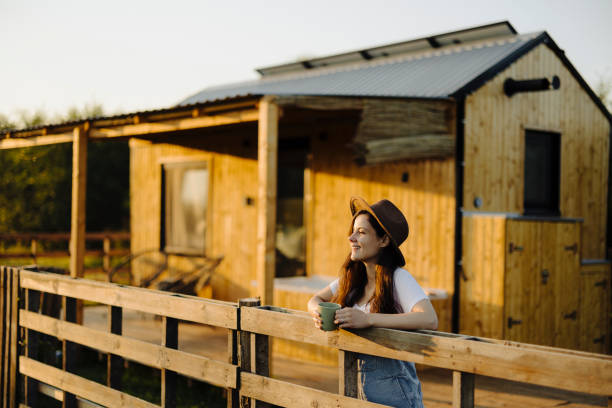 istock Woman drinking coffee in her back yard 2184026068