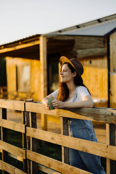 istock Woman drinking coffee in her back yard 2184026439