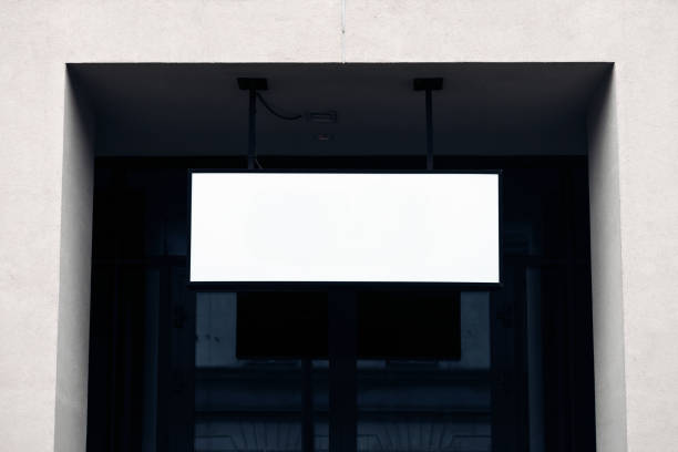 istock Blank white restaurant or shop sign mockup, empty space to display store name mock up template. White empty banner on a wall, front view 2184027583