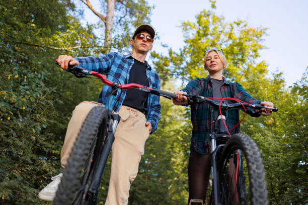 istock Low angle man and woman on bicycles in nature 2184028430