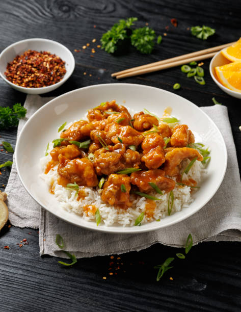istock Chinese orange chicken with rice and green onion garnish 2184030556