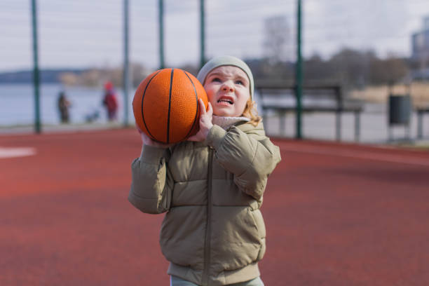 Boy with ball playing basketball