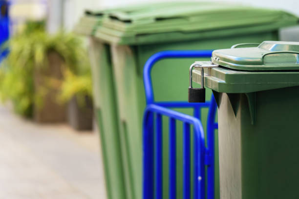 istock plastic trash bin is secured with a padlock, preventing neighbors from disposing of their waste and ensuring they pay for their own disposal services 2184040667