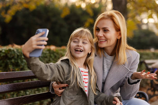 istock A delighted mother and daughter smile as they take a selfie together, capturing a special moment of fun and connection 2184042607