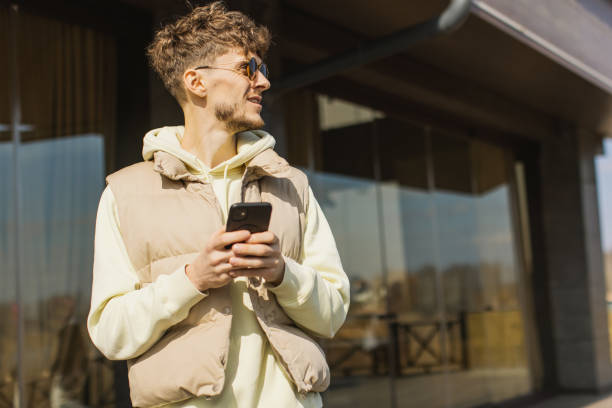 istock Man with mobile phone outdoors 2184044314