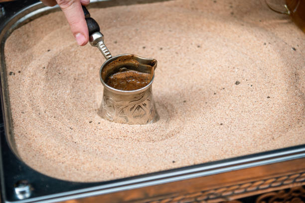 istock Turkish coffee in a cezve on the sand. 2184044867