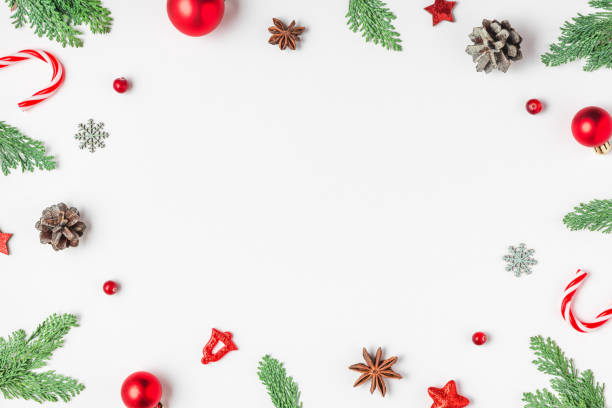 istock Christmas frame made of fir branches, red decorations, candy and pine cones isolated on white background. Flat lay. Happy New Year and winter holidays background. Top view 2184048194