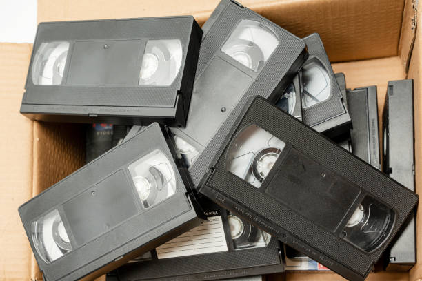 A box full of old black VHS tapes