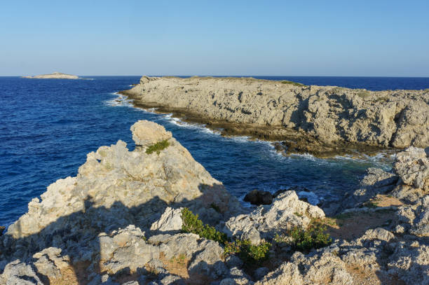 istock A breathtaking coastline at sunset revealing rugged cliffs and deep blue waters near a serene island. 2184052006