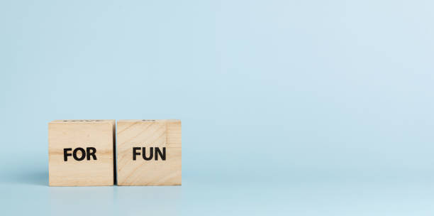 istock Wooden cubes with inscriptions For Fun on a blue background 2184053594