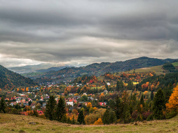 istock Tranquil Autumn Landscape With Village and Rolling Hills 2184056094
