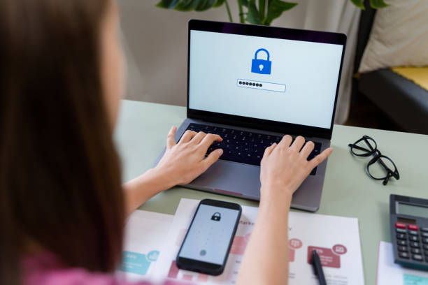 istock Woman typing password on laptop for website security in home office 2184057892