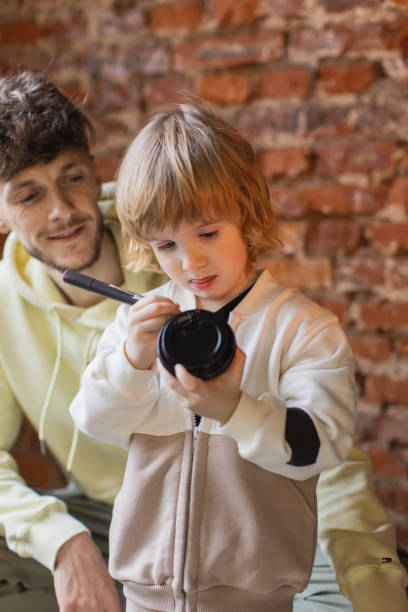 istock Father and son drawing together 2184058159