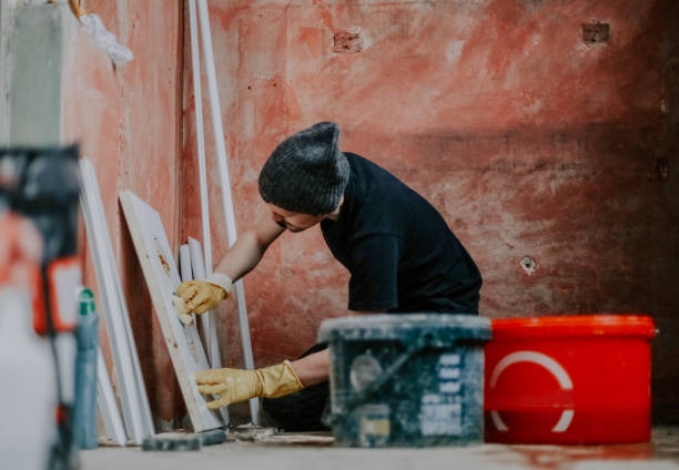 istock One worker washes a dirty plastic part with a sponge. 2184058893