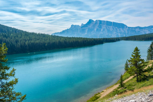 istock Tranquil Lake With Majestic Mountain And Dense Pine Forest 2184059143