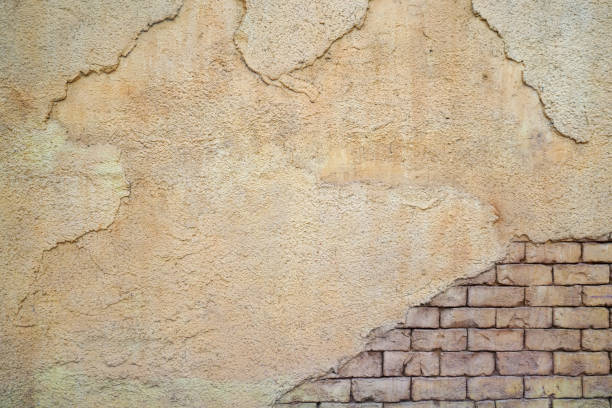 istock Old damaged concrete and brick wall background 2184060299