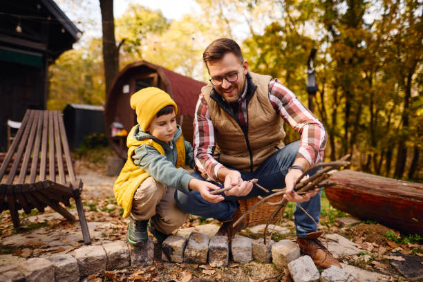 Father and Son Bonding While Camping in Autumn Forest