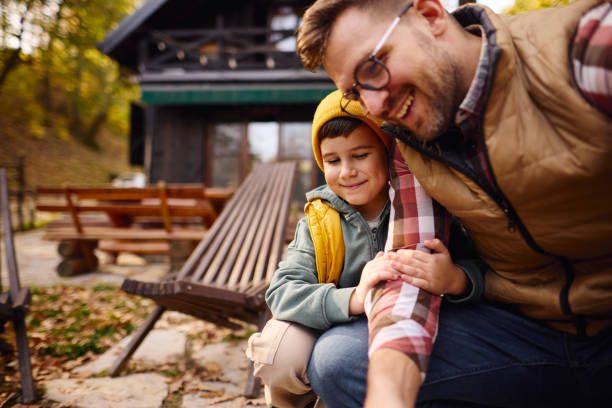 istock Father and Son Enjoying Outdoor Activity Together at Cabin 2184061061