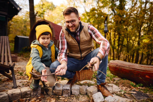 istock Father and Son Bonding While Camping in Autumn Forest 2184061062