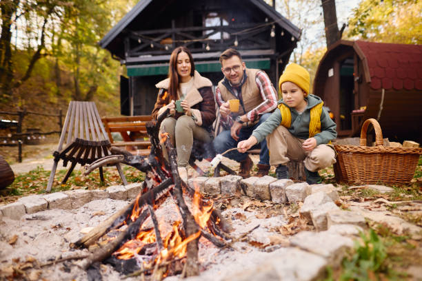 istock Family Enjoying a Cozy Campfire in Autumn Forest 2184061135