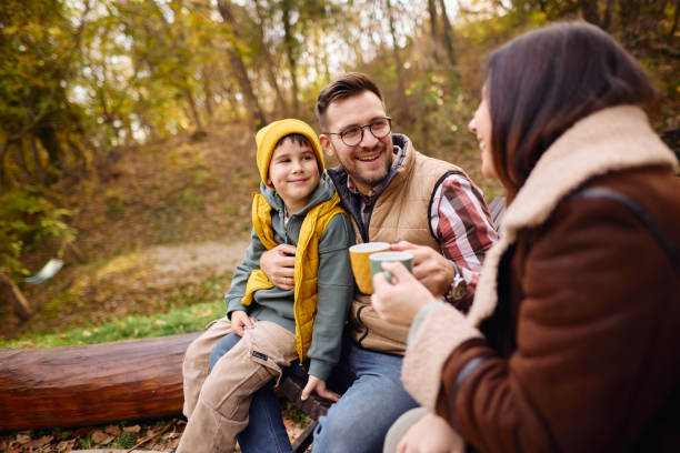 istock Family Enjoying Cozy Campfire Outside a Rustic Cabin in the Woods 2184061237