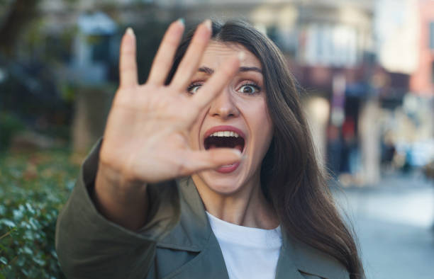 istock Terrified woman showing stop hand sign 2184069064