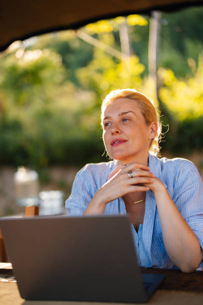 istock Content Woman Enjoying Outdoor Work in Sunny Environment 2184069190