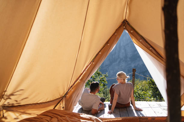 Couple Relaxing in Tent Overlooking Scenic Mountain View