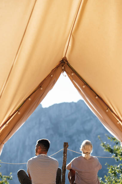 istock Couple Enjoying Mountain View From Inside a Cozy Tent 2184069276