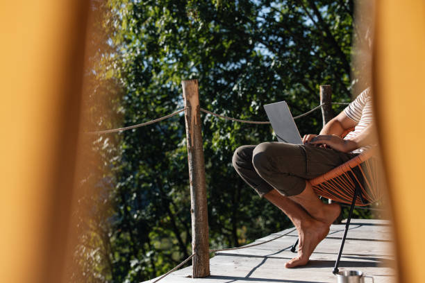 Relaxation on Wooden Terrace with Laptop in Forest Setting