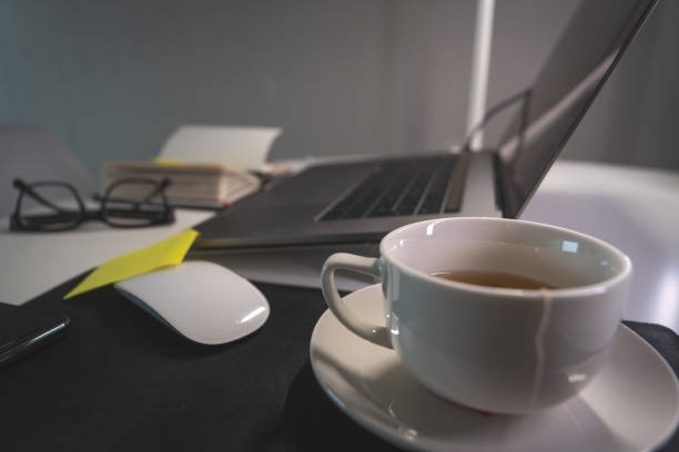 istock A white coffee cup sits on a table next to a laptop 2184072370