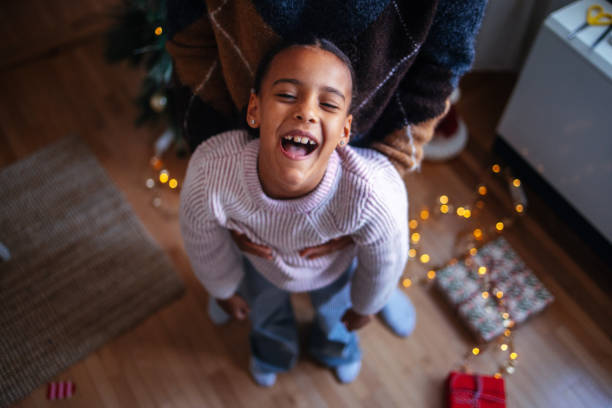 Joyful Child Laughing in Christmas Living Room Setting