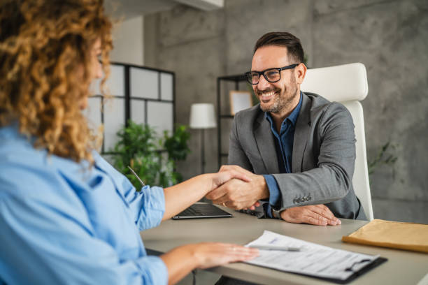 istock colleagues handshake after successful project in the office 2184072987